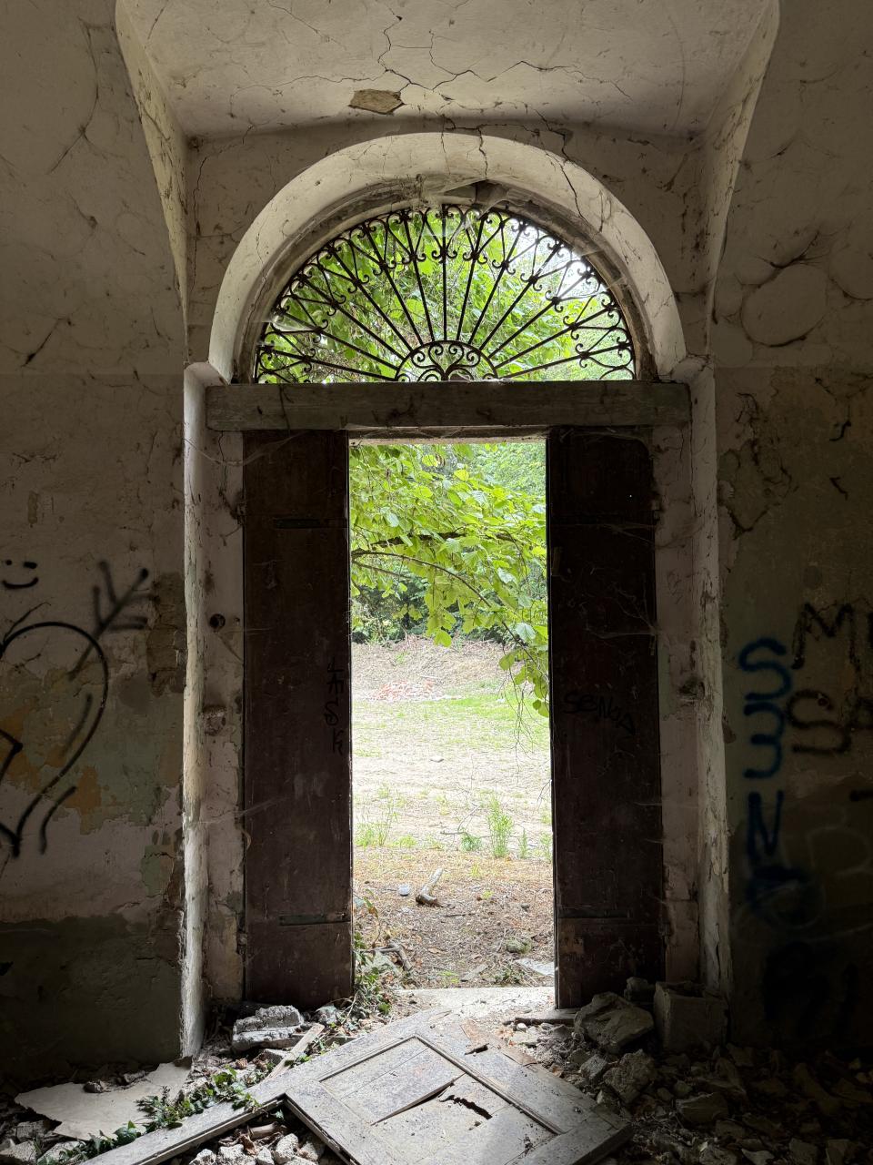 Porte ouverte sur l'extérieur vu depuis l'intérieur d'un bâtiment abandonné 